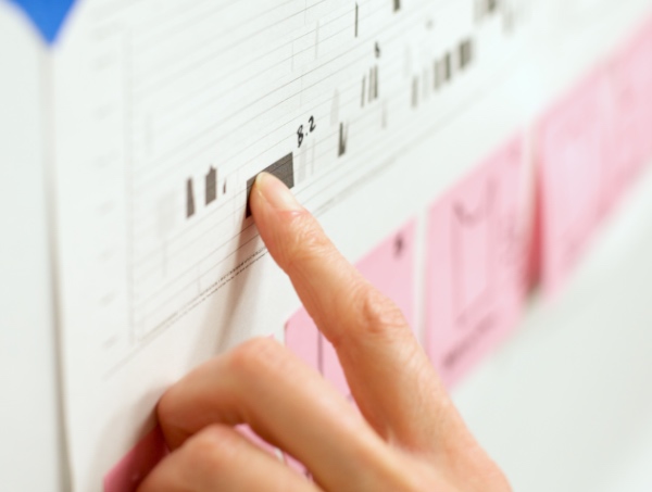 Single index finger pointing up to data on a chart with bokeh effect