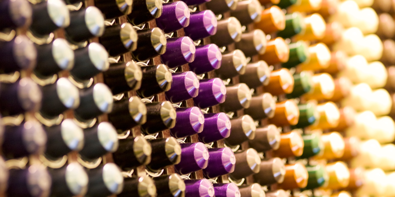 Colorful Nespresso coffee capsules neatly stacked on the wall