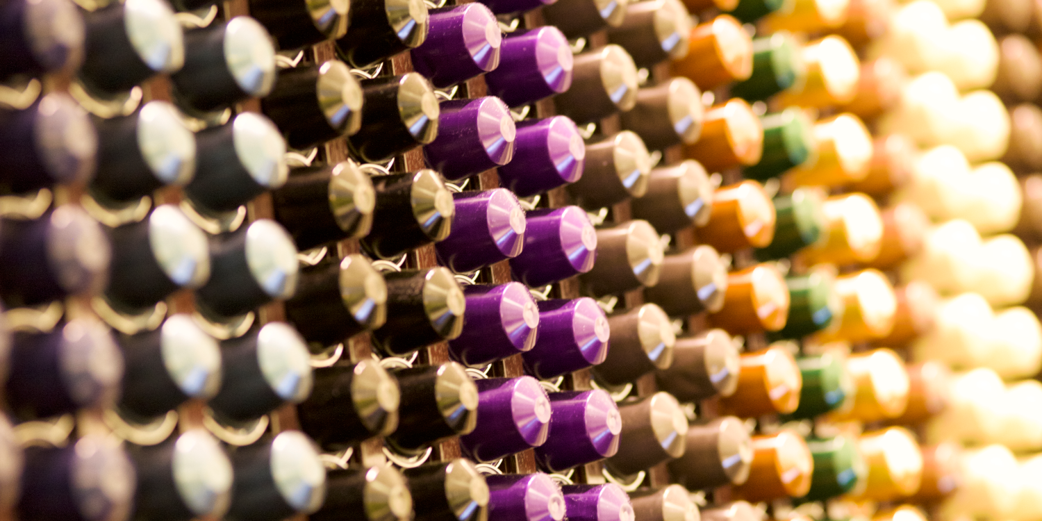 Colorful Nespresso coffee capsules neatly stacked on the wall