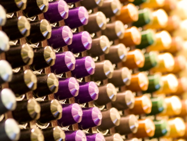 Colorful Nespresso coffee capsules neatly stacked on the wall