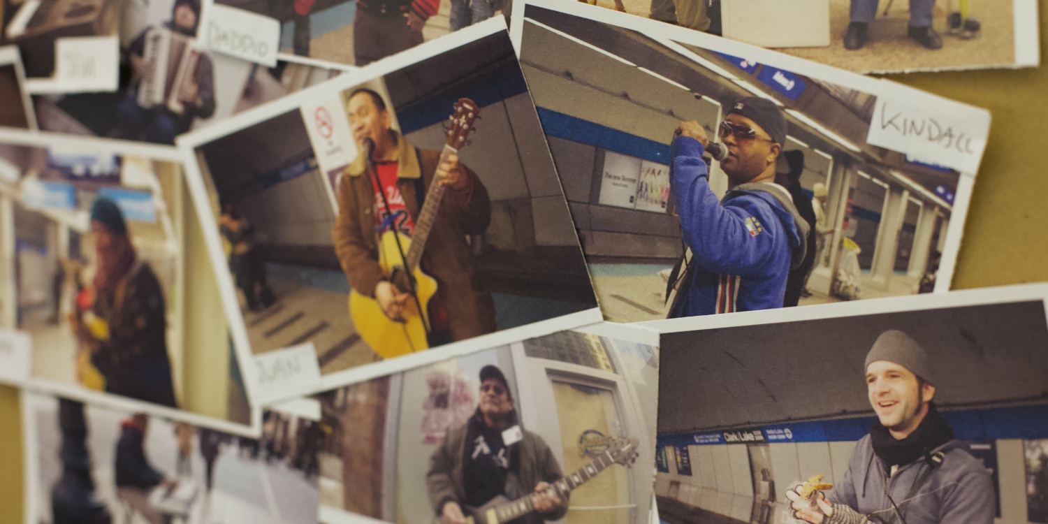 Photos laid out on a table of street music buskers in Chicago